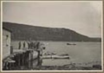 Wharf, showing [Church of England] Parson Gordon's boat [anchored at right background] ca.25 August 1923.