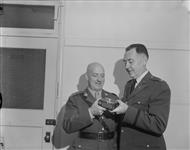 Author's Award.Major Joseph E.R. Duchesne of Quebec City, left, receives the U.S. Army Finance Association Author Award for an article on the Royal Canadian Pay Corps, of which he is a member. The presentation was made at Army Headquarters, Ottawa, by Col. W.E. Sievers, Deputy Chief of Finance, U.S. Army. Major Duchene [sic] is Chief Instructor of the RCAPC Training Wing in Kingston 22 October 1963