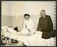 The International Red Cross representative, Mr. Maag, chats with a patient of the Greenwood camp hospital [1943/11-1943/12]