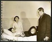 In camp hospitals, babies are born as in any other hospital. This happy mother chats with Dr. Burnett, director of the hospital [1943/11-1943/12]