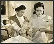 Greenwood hospital nurses with two of the newest arrivals [1943/11-1943/12]