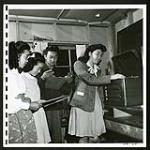 Japanese 'teen-agers in the recreation room of a Rosebery school enjoy jam session records as much as any other young people in British Columbia. Rosebery is a suburb of New Denver [1945/06/16-1945/06/28]