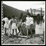 Evacuee children have fun with a boat at Slocan City's beach [1945/06/16-1945/06/28]