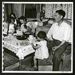 Japanese family have a meal in their Lemon Creek home. Some families are on maintenance, but most are self-supporting--working at lumbering, in stores, or for nieghbouring farmers [1945/06/16-1945/06/28]