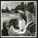 Young Japanese mother truckers her baby in his carriage. She and her husband work for a farmer near Grand Forks [1945/06/16-1945/06/28]