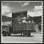 Trucks transport personal and household effects for Japanese who wish to be moved to a re-patriation centre [1945/06/16-1945/06/28]
