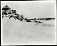 [Houses on the edge of frozen-over river] [1927-1932].