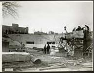 [Two workers converse at the Plaza Bridge expansion construction site] November 10, 1938