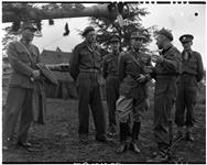 Missions examines captured German fld guns, ack ak, with Lt. Col. A.B. Dove, Toronto, and Lt. Col. D.J. Baldwin, Chiliwack, B.C and Brig. O.C. Mann, Chief of Staff 12 June 1945