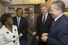 [Prime Minister Stephen Harper visits with Bruce Golding, the Prime Minister of Jamaica, and his wife, Lorna Golding, onboard the Airbus en route to Jamaica following the Summit of the Americas in Port of Spain, Trinidad and Tobago] 19 April 2009