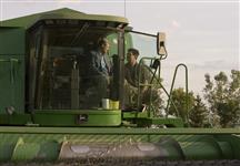 [Prime Minister Stephen Harper chats with farm owner Kevin Eberle as he sits in his John Deere combine during a campaign stop at a local farm in Regina, Saskatchewan] 8 September 2008