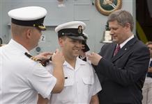 [Prime Minister Stephen Harper awards young sailors with new ranks on the deck of the Canadian naval frigate HMCS Fredericton during his visit to Bridgetown, Barbados] 19 July 2007