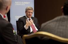 [Prime Minister Stephen Harper meets with Sean Palter and Aly Verjee, Canadian participants in the Young Atlanticists Program, before the start of the NATO Summit in Lisbon, Portugal] 19 November 2010