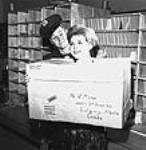 [Postal personnel presenting oversized parcel] [graphic material] 1963