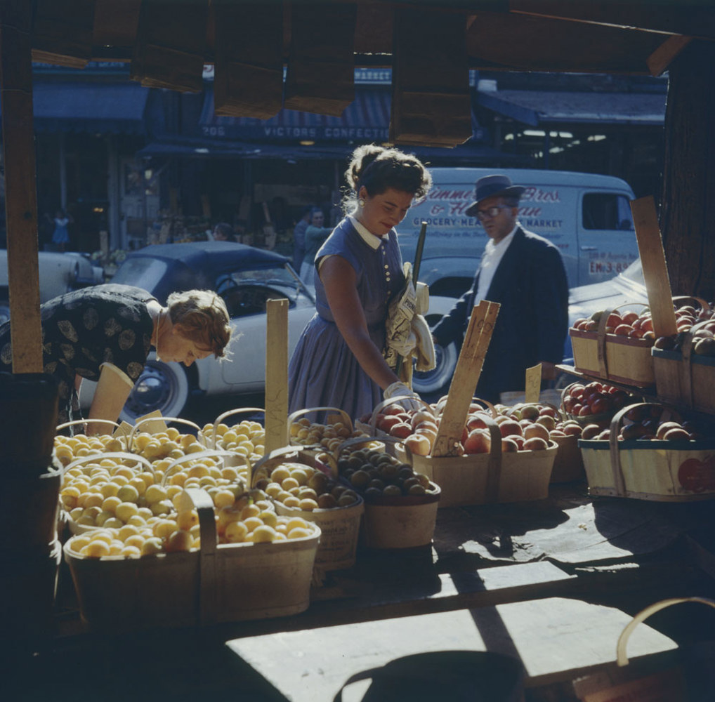 Historic photo from 1957 - Inspecting baskets of peaches in Kensington Market - across from Victors Confectionery at 206 August Ave (?) in Kensington Market