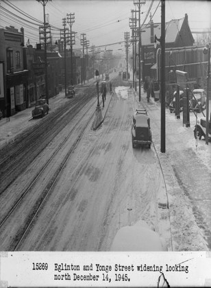 Historic photo from Friday, December 14, 1945 - Eglington and Yonge Street widening looking north - Highland Dairy sign in North Toronto