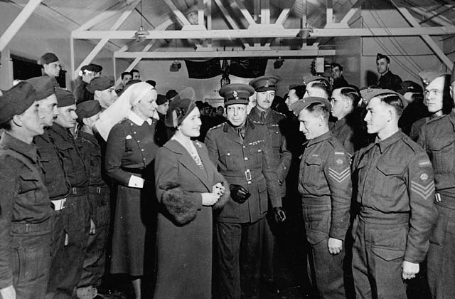 H.M. Queen Elizabeth, accompanied by Matron Agnes C. Neill, talking with personnel of No.15 Canadian General Hospital, Royal Canadian Army Medical Corps (R.C.A.M.C.), Bramshott, England, 17 March 1941.