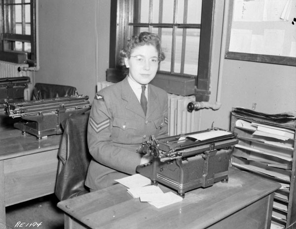 Corporal Helen Grice of the Royal Canadian Air Force (R.C.A.F.) Women's Division working in the Orderly Room of No.168(HT) Squadron, Rockcliffe, Ontario, Canada, 1 March 1944.