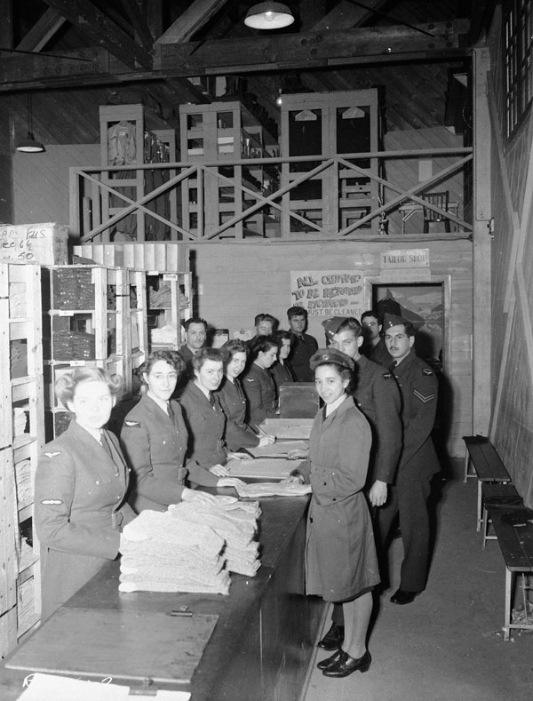Equipment assistants at work in Station Clothing Stores, R.C.A.F. Station Rockcliffe, Ontario, Canada, 31 October 1944.