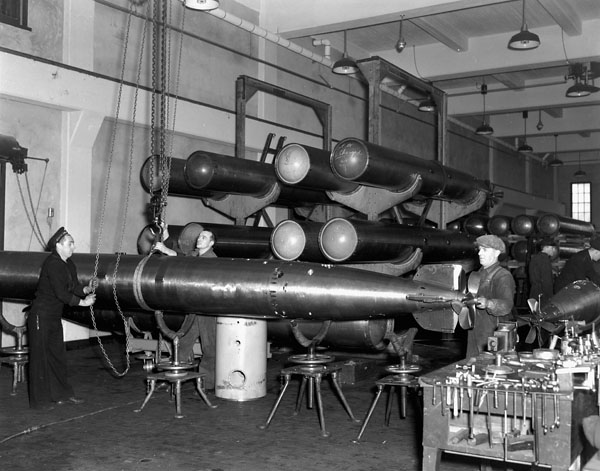 Personnel servicing torpedoes at the R.C.N. Torpedo Depot, Halifax, Nova Scotia, Canada, March 1941.