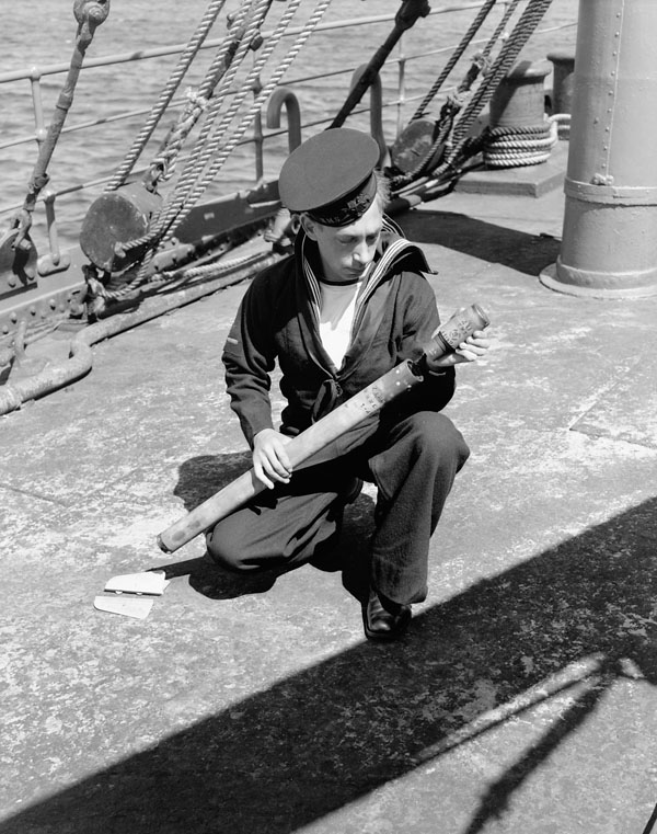 Unidentified naval rating arming a two-inch anti-aircraft rocket projectile fitted to defensively-armed merchant ships. Halifax, Nova Scotia, Canada, June 1941.