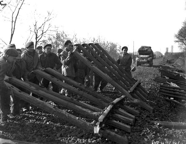 Personnel of the 9th Field Squadron, Royal Canadian Engineers (R.C.E.), clearing a railway roadbed in the Hochwald, Germany, 2 March 1945.
