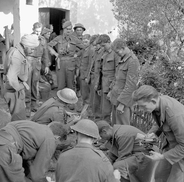 Infantrymen of The Seaforth Highlanders of Canada searching German prisoners on the Moro River front, Italy, 9 December 1943.