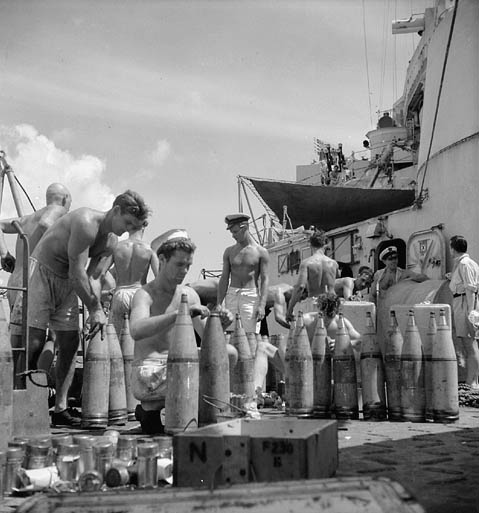 Unidentified personnel of the cruiser H.M.C.S. UGANDA setting shell fuses before the bombardment of Truk, Caroline Islands, 23 June 1945.
