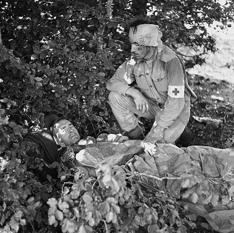 Captain A.W. Hardy, Edmonton, AB, Medical Officer with the West Nova Scotia Regiment, lying wounded, with Pte. W.E. Dexter, a unit stretcher-bearer who was wounded in the head, Santa-Cristina D'Aspromonte, Italy, 8 September 1943.