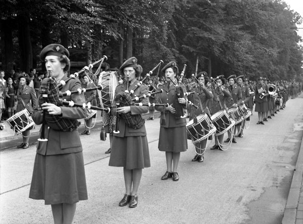 Canadian Women's Army Corps (C.W.A.C.) Pipe and Brass Bands preparing to take part in C.W.A.C. anniversary march past Apeldoorn, Netherlands, 13 August 1945.