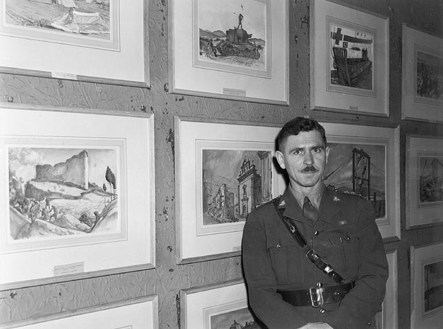 Captain Will Ogilvie, an official war artist of the Canadian Army, with some of his paintings at a Canadian War Art Exhibition, London, England, 9 February 1944.