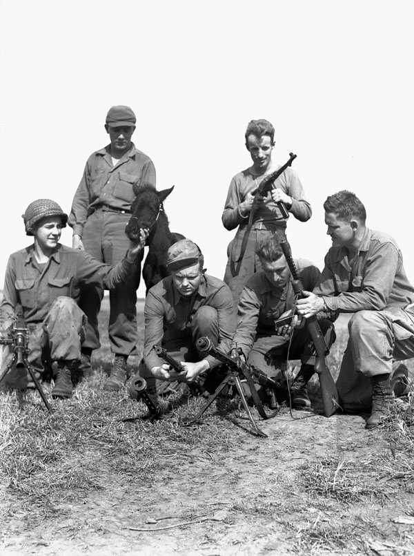 Forcemen of The First Special Service Force, who carry automatic weapons, posing with an Italian colt in the Anzio beachhead, Italy, 20 April 1944.