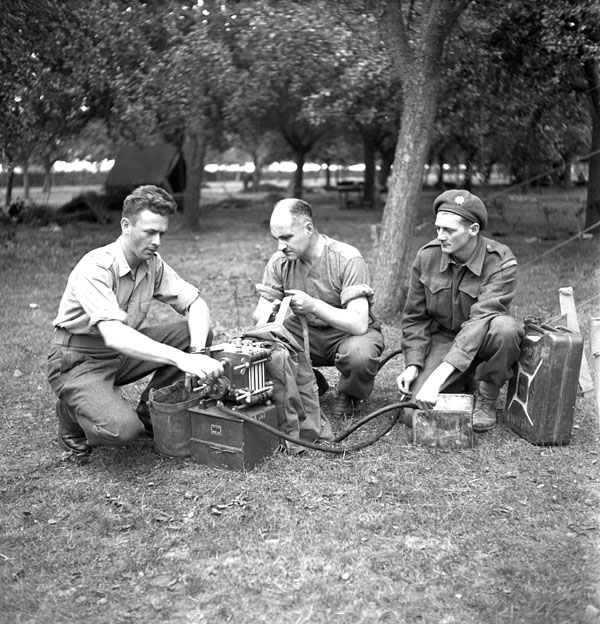 Portable water filter is being tested by Royal Canadian Army Medical Corps (R.C.A.M.C.) members, Falaise, France, 16 August 1944.