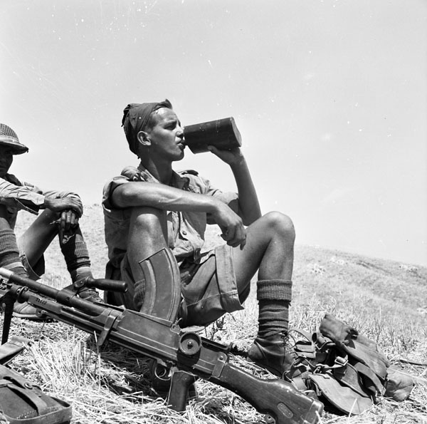 Pte. Stephen Wallace, Princess Patricia's Canadian Light Infantry (P.P.C.L.I.), rests north of Valguarnera, Italy, July 1943.