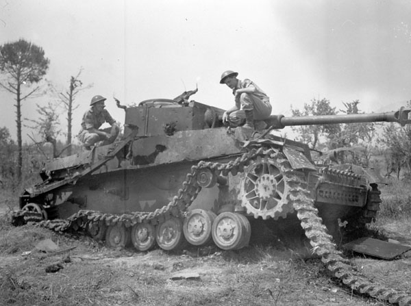Lance-Bombardier T. Hallam and Signalman A.H. Wharf, both of Headquarters, Royal Canadian Artillery (R.C.A.), 5th Canadian Armoured Division, examining a knocked out German Mark IV tank, near Pontecorvo, Italy, 26 May 1944.
