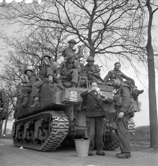Personnel of the Royal Hamilton Light Infantry aboard a Sherman tank of 