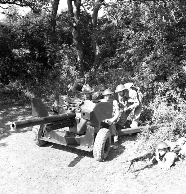 Gunners of the 7th Anti-Tank Regiment, Royal Canadian Artillery (R.C.A.), manning a six-pounder anti-tank gun during a training exercise, Petworth, England, 10 September 1942.