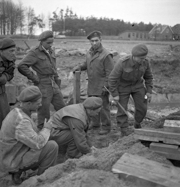 Personnel of the 7th Field Company, Royal Canadian Engineers (R.C.E.), reconstructing the bridge joining Terborg and Doetinchem, Netherlands, 1 April 1945.