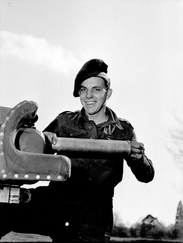 Private G.K. McCaw of The Highland Light Infantry of Canada loading a six-pounder anti-tank gun during a training exercise, England, 13 April 1944.