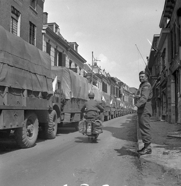 A convoy of trucks of Allied food supplies moving into German-occupied territory along the road from Wageningen to Rhenan, Netherlands, 3 May 1945.