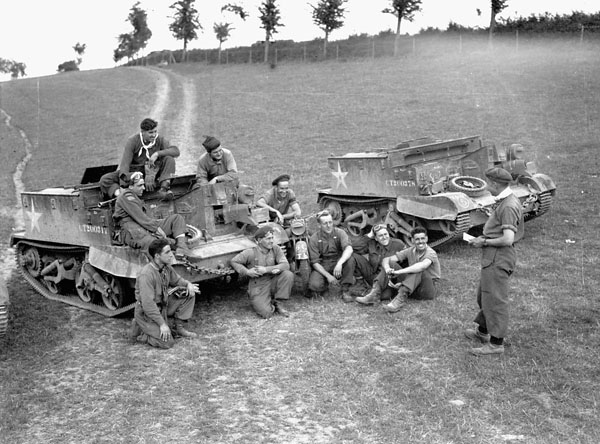 Lieutenant Stan Biggs briefing Universal Carrier flamethrower crews of The Queen's Own Rifles of Canada, Vaucelles, France, 29 July 1944.