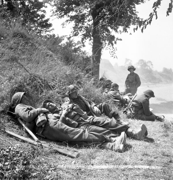 Infantrymen of The Highland Light Infantry of Canada resting alongside the Orne River en route to Caen, France, 18 July 1944.
