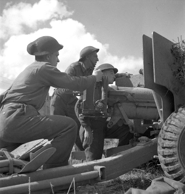 Private L.P. McDonald and Lance-Corporals W. Stevens and R. Dais, all of the Royal Canadian Artillery (R.C.A.), manning a six-pounder anti-tank gun, Nieuport, Belgium, 9 September 1944.