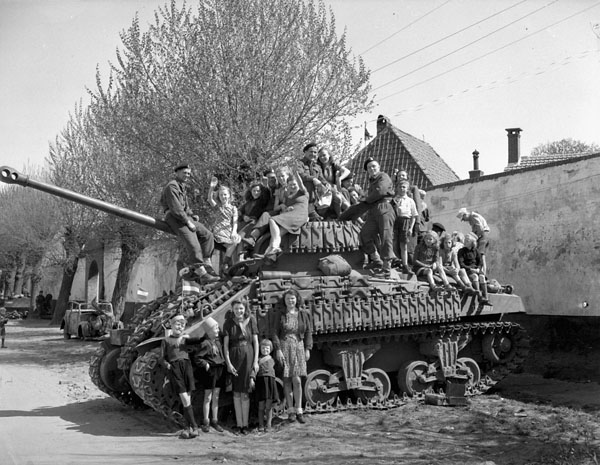 Dutch women and children sitting on a Sherman VC Firefly tank of Lord Strathcona's Horse (Royal Canadians)