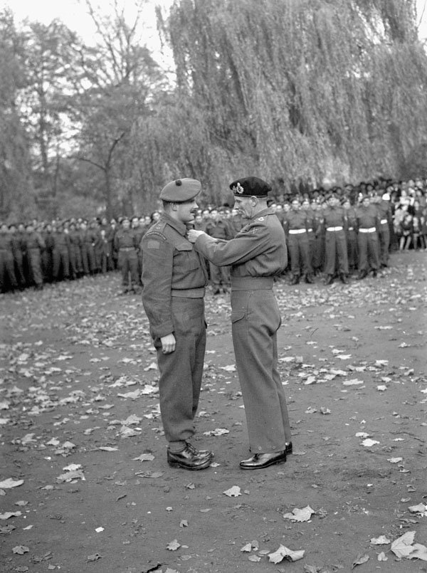 Field Marshal Sir Bernard Montgomery investing Lieutenant W.T. Sharp of The Cameron Highlanders of Ottawa (M.G.) with the Military Cross, Ghent, Belgium, 5 November 1944.
