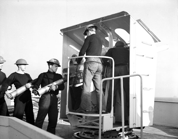 Crew of a four-inch gun of the frigate H.M.C.S. NEW GLASGOW off the coast of British Columbia, Canada, ca. 1944.