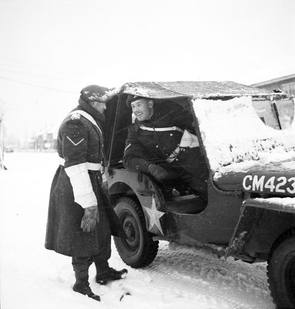 Lance-Corporal Eddie Halverson (left) talking to Lance-Corporal Phil LaRoque, Nijmegen, Netherlands, ca. 9 January 1945.