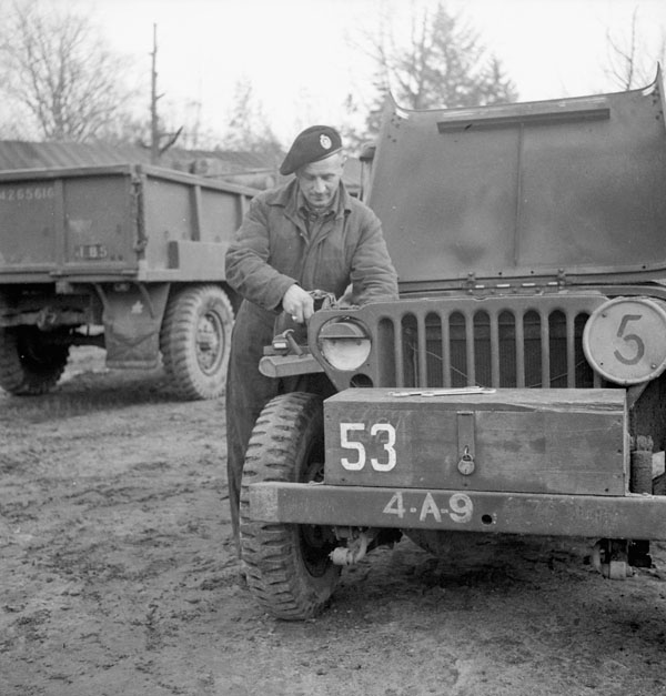 Corporal Harry Maud of 'B' Squadron, The British Columbia Regiment, with a jeep, Helvoirt, Netherlands, 18 November 1944.