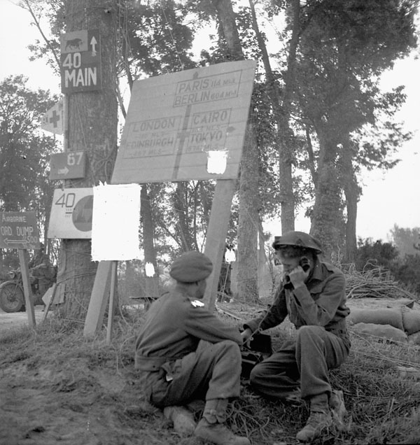 Royal Canadian Corps of Signals (R.C.C.S.) personnel of the 3rd Canadian Infantry Division operating a field telephone near London Bridge on the Orne River, France, 18 July 1944.
