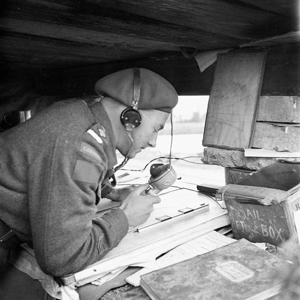 Lieutenant L.W. Spurr directing the fire of the 25-pounder guns of the 4th Field Regiment, Royal Canadian Artillery (R.C.A.), near Antwerp, Belgium, 30 September 1944.